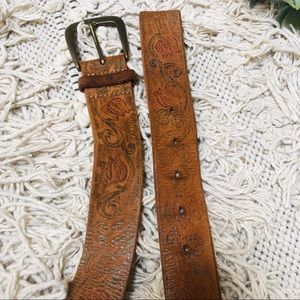 Leather belt with floral embellishments.